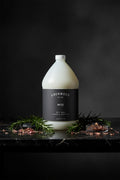 Gallon bottle of Lockwood New York body wash with a dark label on a white background