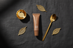 Sahajan Luxury Lip Care Set of 10 flat lay overhead on dark charcoal linen surface with gold accent props