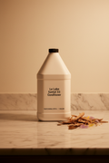 Le Labo Santal 33 1-gallon conditioner professional refill bottle on marble vanity — luxury hotel amenity supply for Fairmont, Park Hyatt, Airbnb STR, superyacht and private aviation