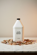 Le Labo Santal 33 1-gallon body wash professional refill bottle on marble vanity — luxury hotel amenity supply for Fairmont, Park Hyatt, Airbnb STR, superyacht and private aviation